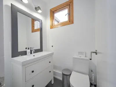 a bathroom with a sink and a mirror and a toilet at BarcelonaForRent Alessandra Ramblas in Barcelona