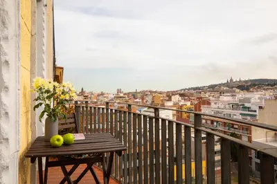 a balcony with a wooden table with apples on it at Casa Cosi - Sants in Barcelona