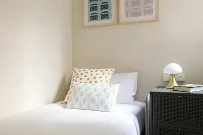 a bedroom with a bed with a pillow on it at Casa Cosi - Sants in Barcelona