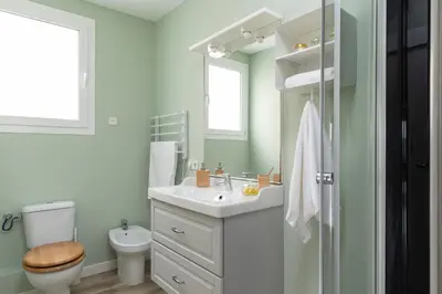 a bathroom with a white sink and a toilet at Casa Cosi - Sants in Barcelona
