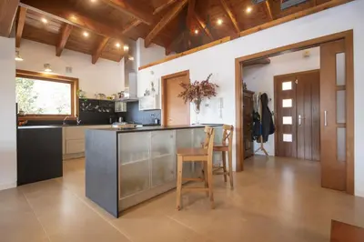 a large kitchen with a counter and a table at Catalunya Casas Infinity pool and views 20min to Barcelona in Torrelles de Llobregat