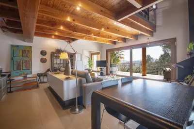 a living room with a couch and a table at Catalunya Casas Infinity pool and views 20min to Barcelona in Torrelles de Llobregat