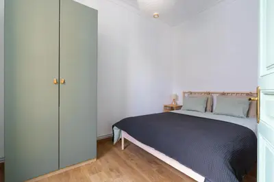 a white bedroom with a bed and a closet at Modernist Family Apartment by PriorityVillas in Barcelona