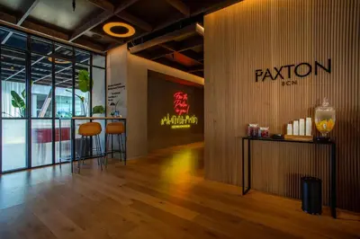 a lobby of a restaurant with a sign on the wall at Hotel Paxton Barcelona in Barcelona