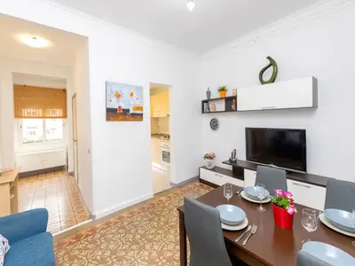 a dining room and living room with a table and chairs at Apartment Gracia- Providencia by Interhome in Barcelona