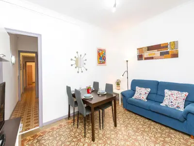 a living room with a blue couch and a table at Apartment Gracia- Providencia by Interhome in Barcelona