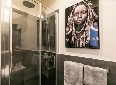 a bathroom with a poster of a woman with a necklace at Avinyo 2 Gotic · Spacious Loft in Gothic Quarter! in Barcelona
