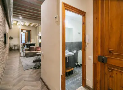 a hallway with a door leading to a living room at Avinyo 2 Gotic · Spacious Loft in Gothic Quarter! in Barcelona