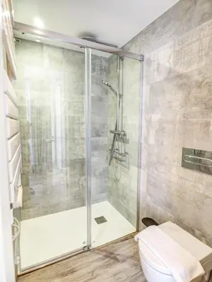 a bathroom with a shower and a toilet at Blue Serenity by Hello Homes Sitges in Sitges