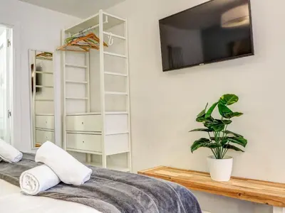 a bedroom with a bed with a tv on the wall at The Green Oasis by Hello Homes Sitges in Sitges