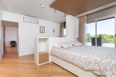 a bedroom with a bed and a large window at HHBCN Beach Apartment Gava #2 in Gavà