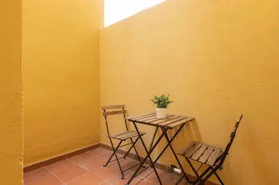 a small table with two chairs and a plant on it at Housalia Sagrada Familia in Barcelona