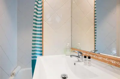 a bathroom with a sink and a mirror at Housalia Sagrada Familia in Barcelona