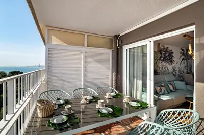 a balcony with a table and chairs with a view of the ocean at LIANA SEAVIEW & BEACH - apartment in Montgat