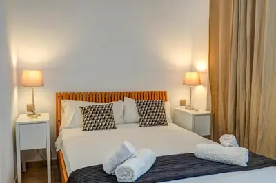a bedroom with a bed with two towels on it at La Marina Sea Front by Hello Homes Sitges in Sitges