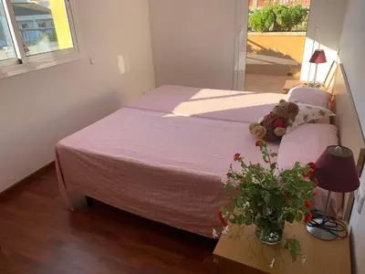 a bedroom with a bed with a teddy bear on it at Villa Dacar in Cubelles