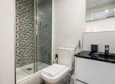 a bathroom with a toilet and a sink and a shower at DUPLEX NEAR THE BEACH Barceloneta in Barcelona