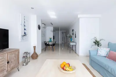 a living room with a blue couch and a bowl of fruit at vilasardemarlux3 in Vilassar de Mar