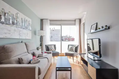 a living room with a couch and a tv at Alcam Rubi in Rubí