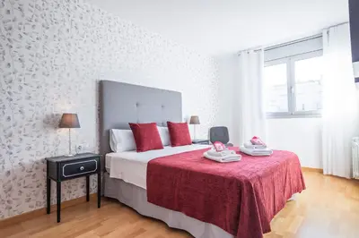 a bedroom with a large bed with red pillows at Alcam Rubi in Rubí