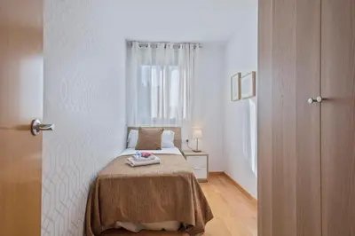 a bedroom with a bed and a window at Alcam Rubi in Rubí