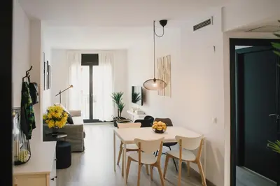 a living room with a white table and chairs at BBarcelona Central Boutique Apartments in Barcelona