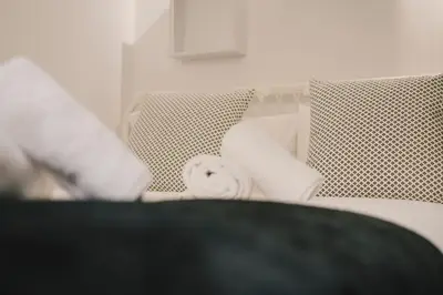a close up of a bed with two chairs at BBarcelona Central Boutique Apartments in Barcelona