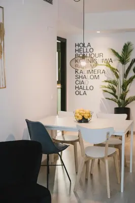 a white dining room with a white table and chairs at BBarcelona Central Boutique Apartments in Barcelona