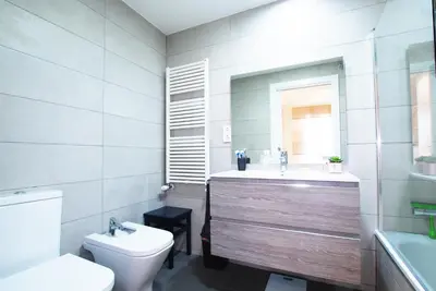 a bedroom with a bed and a large window at Cozy Home · Cozy Home · Nice apartment w/pool and private terrace in Mataró