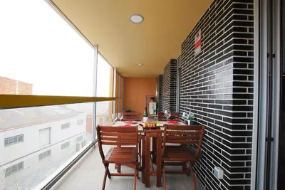 a dining room with a table and chairs on a balcony at Cozy Home · Cozy Home · Nice apartment w/pool and private terrace in Mataró