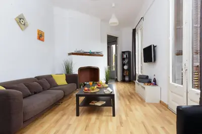 a living room with a couch and a table at Key Plaza Universidad - Gran Via in Barcelona