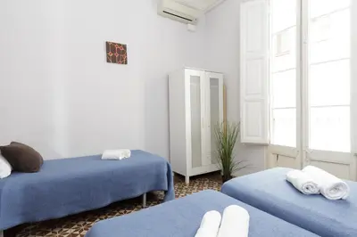 a room with two beds with blue sheets at Key Plaza Universidad - Gran Via in Barcelona