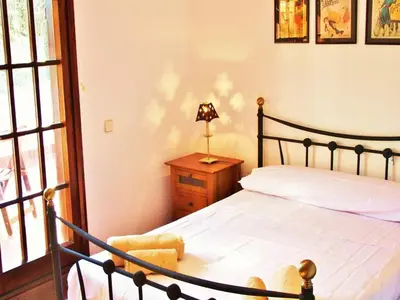 a bedroom with a bed and a lamp on a table at Villa in Sant Pol near Crystal Beach in San Pol de Mar