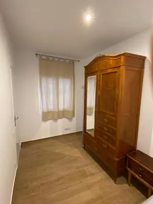 a room with a wooden cabinet and a window at VIU BARCELONA BERTRAN in Barcelona