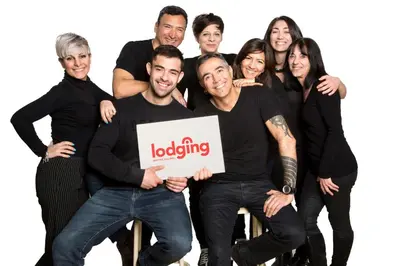 a group of people holding a loading sign at Kronos on the Beach Attic Suite in Barcelona
