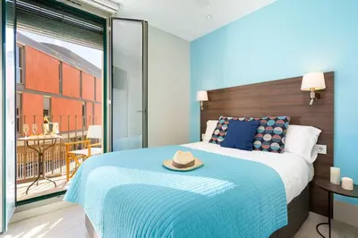 a bedroom with a bed with a hat on it at Kronos on the Beach suite 1 in Barcelona