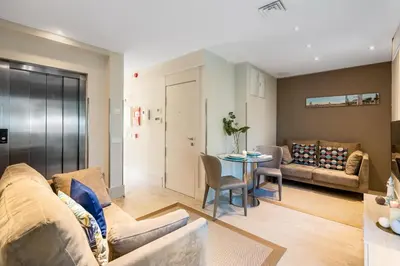 a living room with a couch and a table at Kronos on the Beach suite 1 in Barcelona