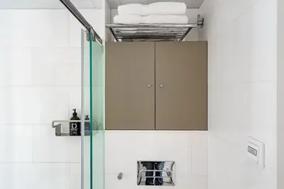 a shower with a glass door in a bathroom at Kronos on the Beach suite 3 in Barcelona