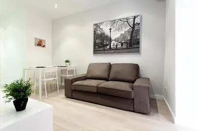 a living room with a couch and a table at MIQUEL ANGEL - Apartments & one with private terrace in Barcelona