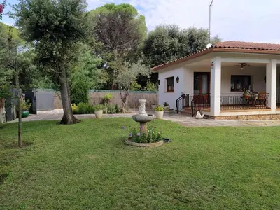 a house with a yard with a statue in the grass at Casa en Parque Natural del Montseny. in Santa María de Palautordera