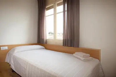 a bedroom with a white bed with a window at RIUS - Apartments & one Penthouse with private terrace in Montjuic in Barcelona