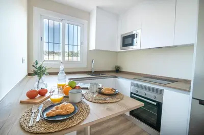a kitchen with a table with bread and fruit on it at RIUS - Apartments & one Penthouse with private terrace in Montjuic in Barcelona