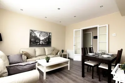 a living room with a couch and a table at RIUS - Apartments & one Penthouse with private terrace in Montjuic in Barcelona