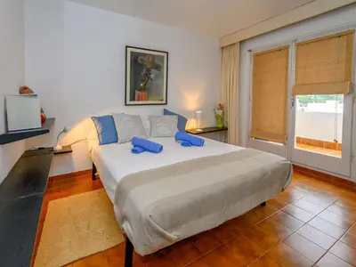 a bedroom with a large bed and a window at Holiday Home La Marina Blanca by Interhome in San Pol de Mar