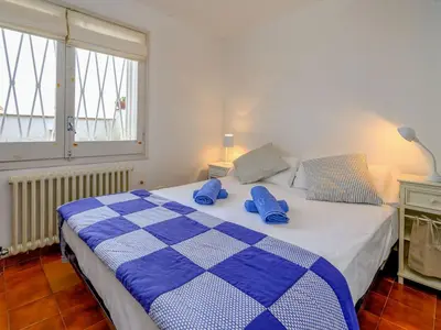 a blue and white bed with blue pillows on it at Holiday Home La Marina Blanca by Interhome in San Pol de Mar