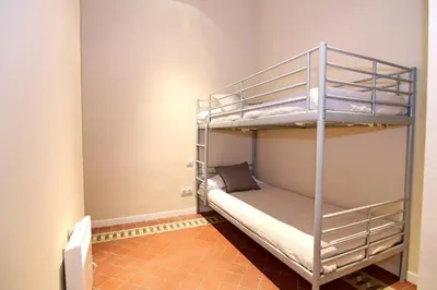 a room with two bunk beds in a room at GIRONA - Modernist apartments next to Paseo de Gracia in Barcelona