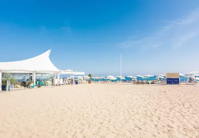 a beach with a bunch of umbrellas on it at HomeHolidaysRentals Moana in Calella