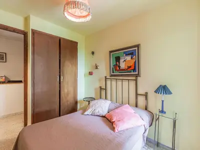 a bedroom with a bed with pink sheets and a lamp at Villa in Maresme near Montnegre Park in Sant Iscle de Vallalta