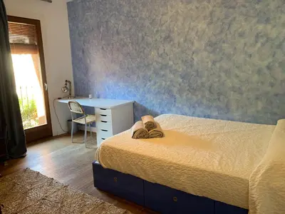 a bedroom with a bed and a desk and a table at Cal Secretari in Rellinars