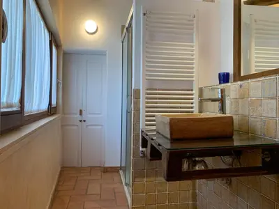 a bathroom with a sink on a counter with a mirror at Cal Secretari in Rellinars